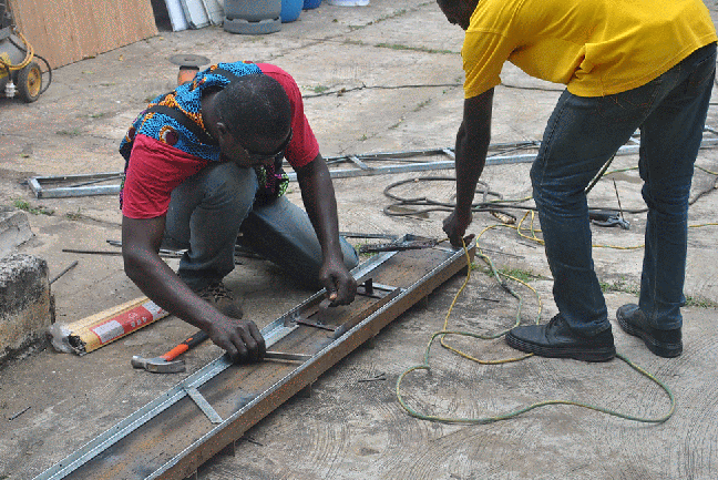 tack weld outer frame of 2d truss in jig then use spacer to precisely set out 1in flat bar lengths.